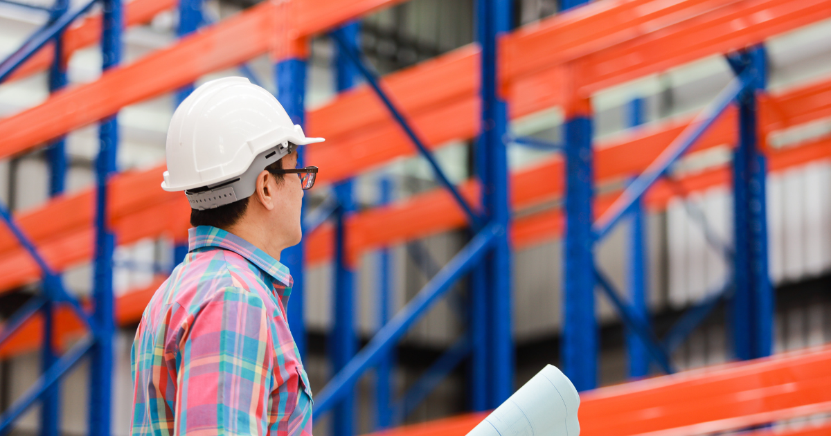 A warehouse manager doing Pallet Rack Inspection in the storeroom m